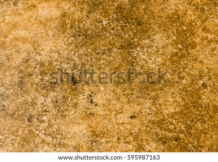 Close-up shot of a brown-orange stone taken in natural environment, suitable for use as a texture or background for your next project. Seamless pattern tile.