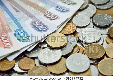 various russian banknotes on the coins surface