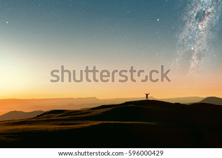 The man in mountains against the background of stars