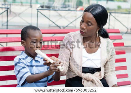 This child learns to play the flute with his teacher.