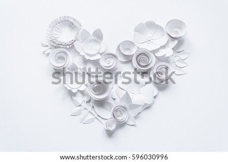 Heart from white paper flowers on white background. Cut from paper.