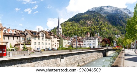 Chur, Switzerland -: Panorama of the old town by train of the Rhaetian Railway in the foreground Royalty-Free Stock Photo #596046509