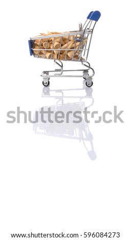 Concept image of wooden golf tee in a mini shopping cart over white background