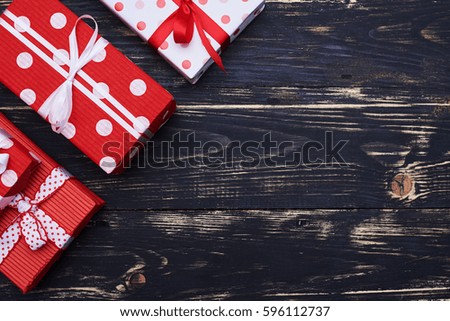 High angle view of three different gift boxes in the top left corner with copy space. Boxes wrapped in paper