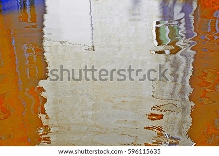 House flooded colorful frame with window. Reflection home in puddle. Colors photo: orange, grey. City life, water reflections. 