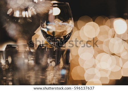 Blurred picture of glassware standing on the table Royalty-Free Stock Photo #596137637