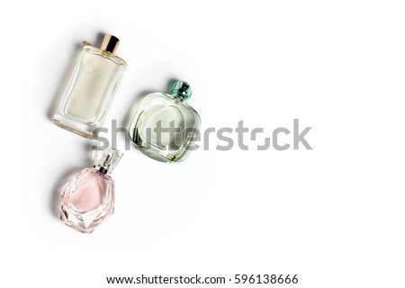 Perfume bottles on light background. Perfumery, cosmetics, fragrance collection. Free space for text