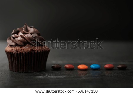 Chocolate cupcake with colorful candy in Dark lighting, AF point selection.