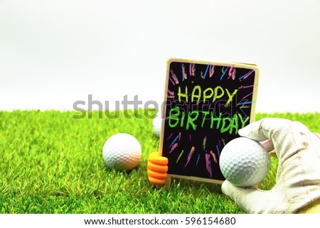 Golf ball with Happy birthday wording on green grass