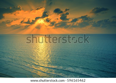 Early morning, sunrise over sea. Blue orange beautiful sunrise. Twilight time on the beach. Wild nature.