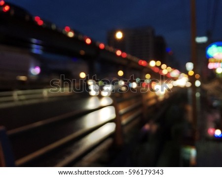 Image of night road with blue focus and light bokeh.