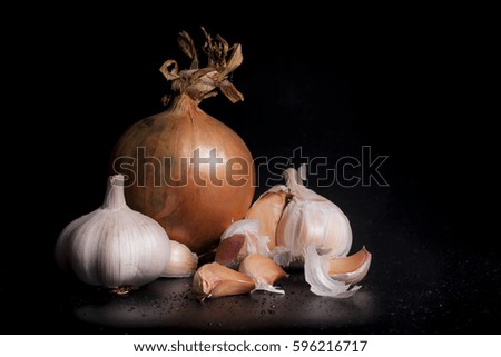 Garlic and onions on a black background
