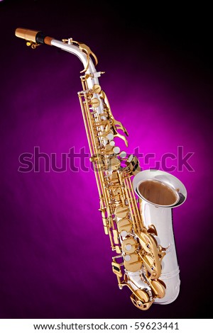 A silver and gold alto saxophone isolated against a spotlight pink background in the vertical format.