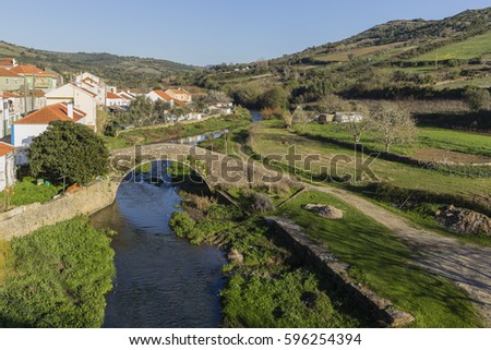 View over the river lizandro in village of Cheleiros Royalty-Free Stock Photo #596254394