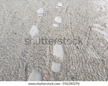 Footprints walking on the beach
