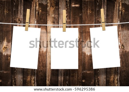 Photo frames with pins on rope over old aged wood wall background