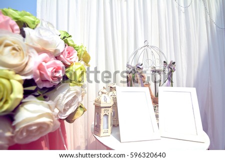 Wedding pictures on the background fabric, decorative white flower bouquet.