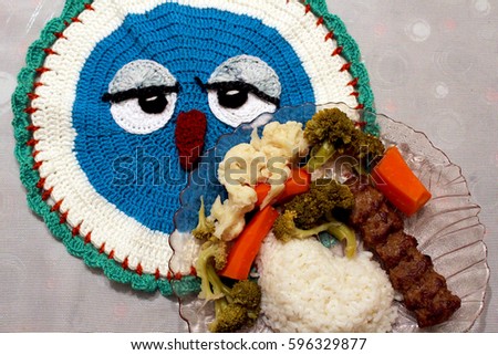 Heart-shaped rice with meatball and fresh vegetables on handmade place mat