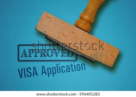 Text Visa Application and rubber stamp on blue background Royalty-Free Stock Photo #596401283