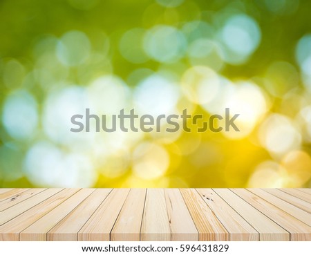 Wood table or wood floor with abstract green bokeh background for product display