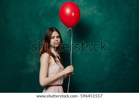 Woman in a dress with red balloon