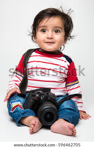 Indian cute little baby /infant or toddler holding DSLR camera, want to be a photographer