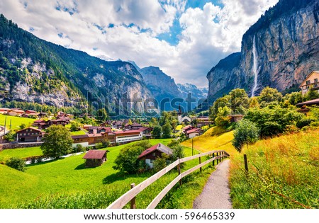 Sunny summer view of great waterfall in Lauterbrunnen village. Splendid outdoor scene in Swiss Alps, Bernese Oberland in the canton of Bern, Switzerland. Beauty of countryside concept background. Royalty-Free Stock Photo #596465339