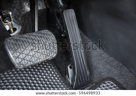 Automobile accelerator and brake pedal Royalty-Free Stock Photo #596498933