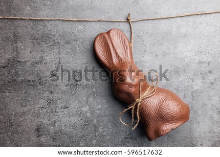 Delicious traditional Easter chocolate bunny hanging on a string