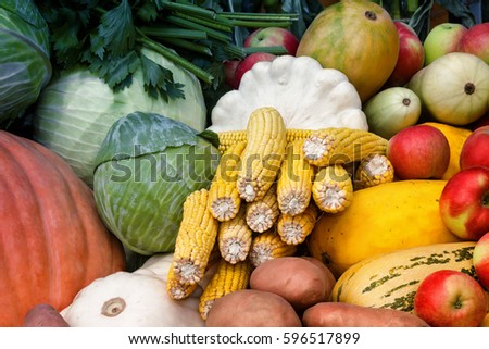 A variety of vegetables: potatoes, pumpkin, squash, corn, cabbage, apples offered for sale at the fair.