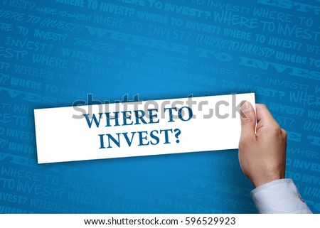 Businessman holding Where to invest? sign