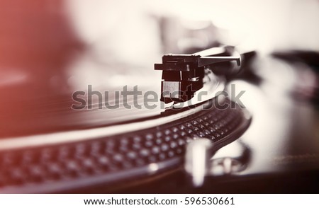 Turntables needle on vinyl record. DJ turn table record player playing analog disc with music. Professional hi fi audio equipment for audiophile. Listen to the music in high fidelity quality