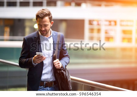 View of a Young attractive business man using smartphone Royalty-Free Stock Photo #596546354