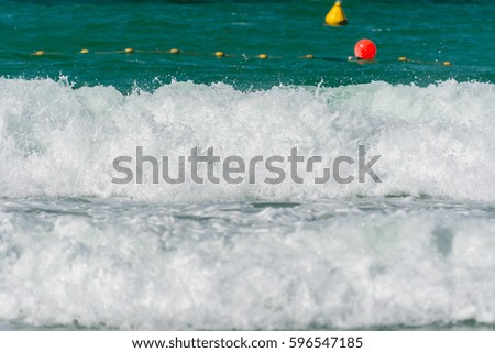 Waves,  water splash flushing beach at Jumeirah beach at Persian gulf in Dubai, United Arab Emirates.