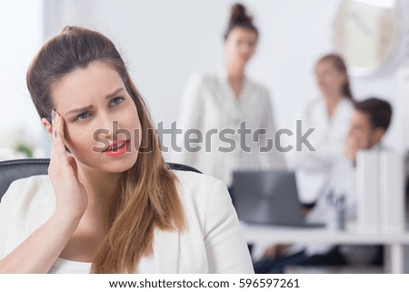 Woman with pregnancy symptoms, sitting at bright office