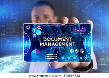 Business, Technology, Internet and network concept. Young businessman showing a word in a virtual tablet of the future: Document management