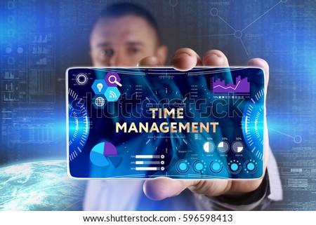 Business, Technology, Internet and network concept. Young businessman showing a word in a virtual tablet of the future: Time management