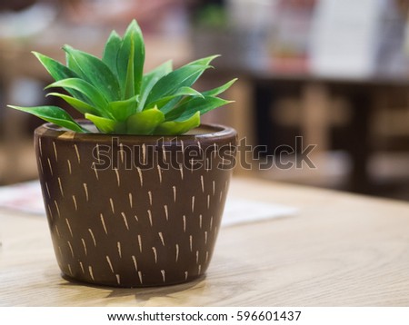 Tree plastic pots on the table in restaurant.