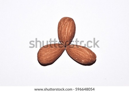 Top view of three almond nuts isolated on white background