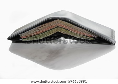Men's leather wallet full of money isolated on white background