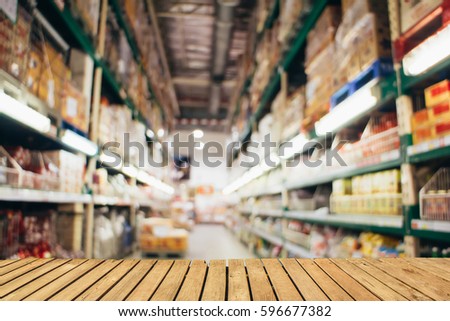 Abstract blurred photo of shopping zone background,Empty wooden shelf on background. For display or montage your products.
