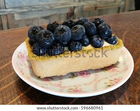 Start your day with homemade Gourmet pastry fresh blueberry cheese cake on vintage flora dish on wood table in cafe with blur background, blueberry pie, tea time,side view