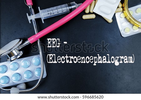 EEG - Electroencephalogram word, medical term word with medical concepts in blackboard and medical equipment.