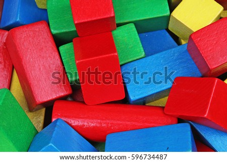 Red, Blue, Yellow Green Wooden toy blocks on white background. Wood block texture pattern.