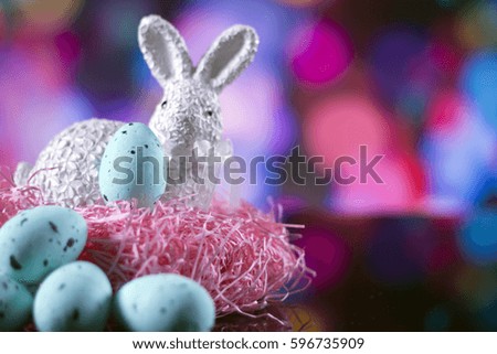Easter rabbit with eggs. colorful bokeh. place for typography