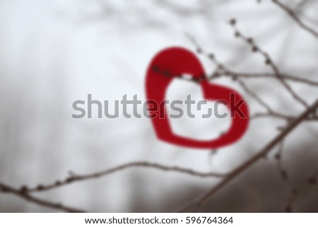 Blurred background of red heart decoration hanging on a branch, Valentine day concept..