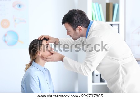 Adult male doctor examining patient Royalty-Free Stock Photo #596797805