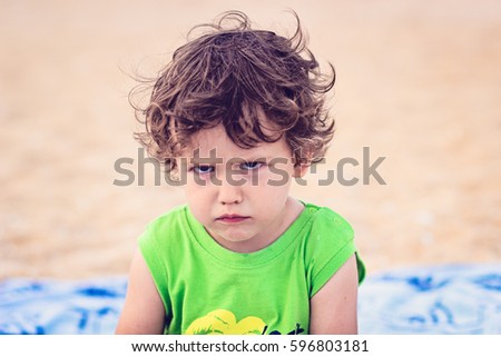 Portrait of toddler boy with angry upset face expression Royalty-Free Stock Photo #596803181