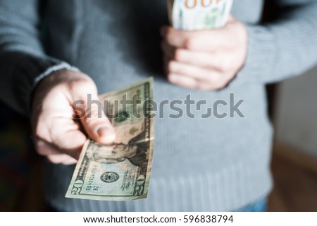 Man giving us dollar banknote and holding cash in hands. Money credit concept. Selective focus