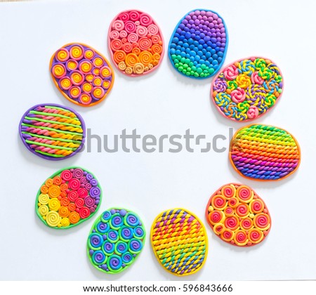 Easter eggs stuck together from plasticine. White background.